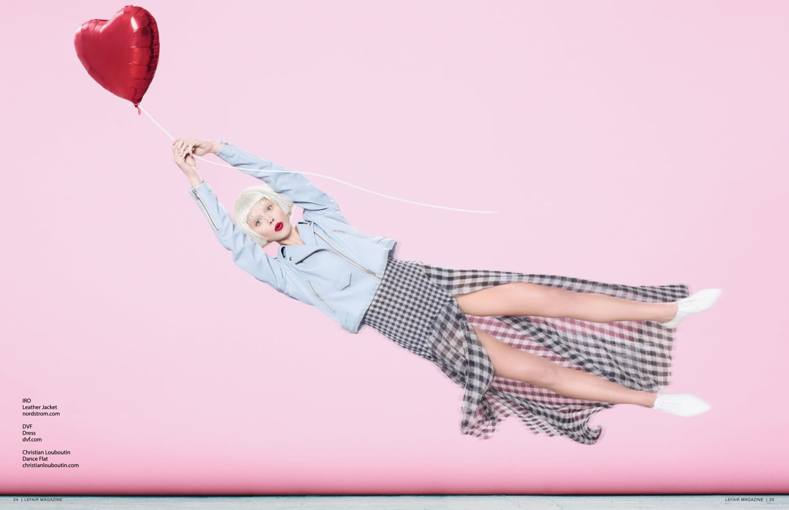 woman holding red heart balloon